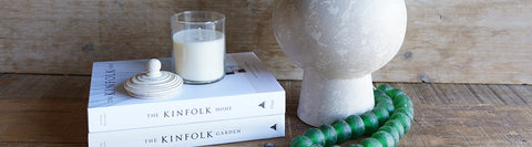 Decorative obects of vase, beads, candle and books